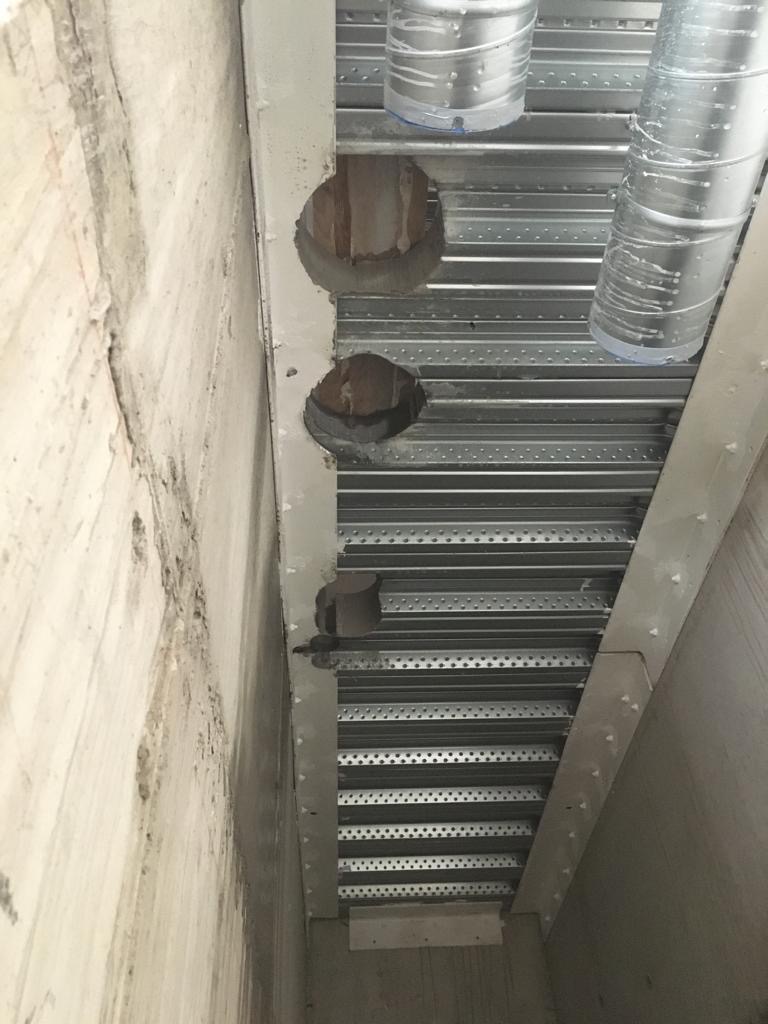 Multiple core holes drilled through concrete ceiling deck
